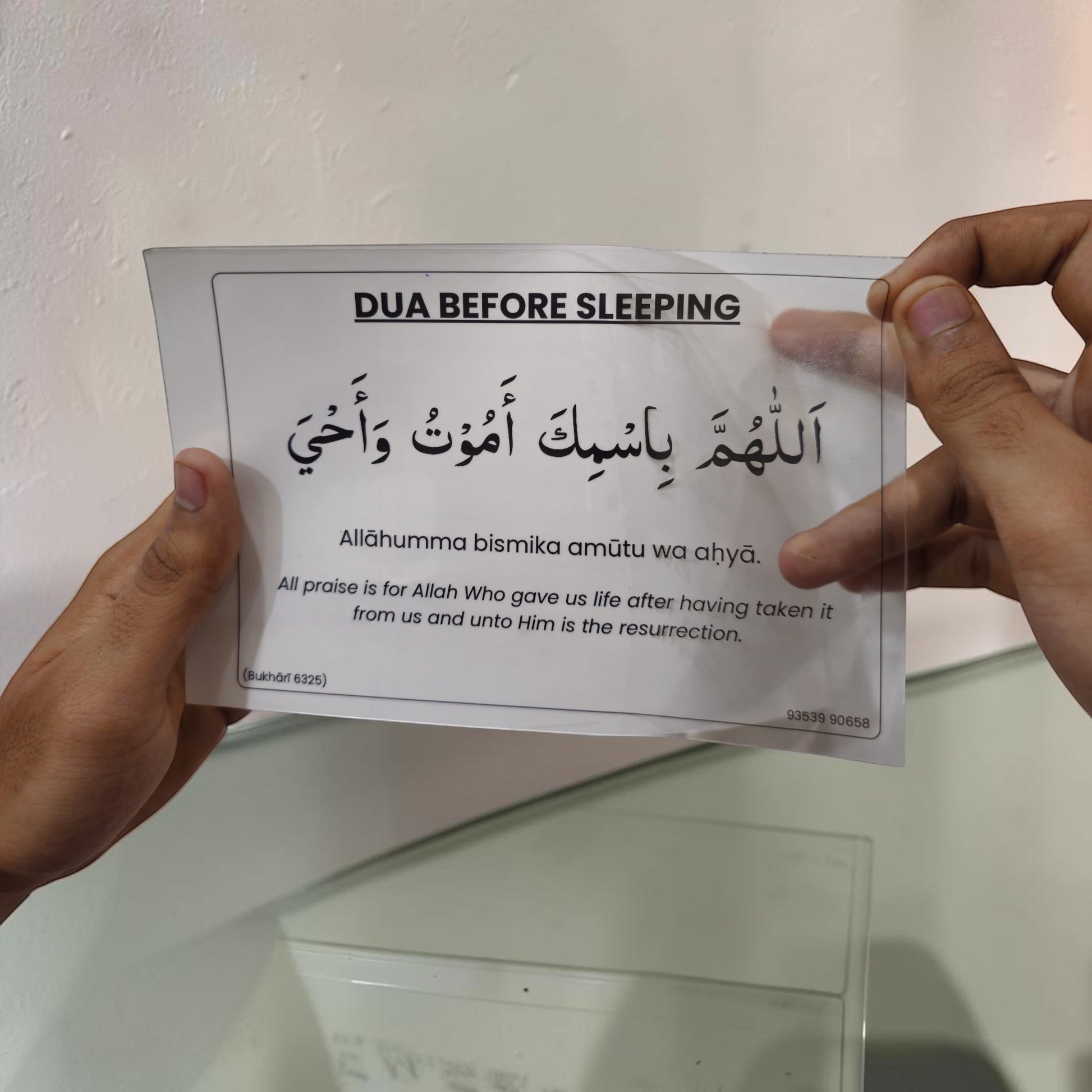 Waterproof English Dua Sticker being applied to a wall or mirror.